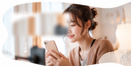 スマートフォンを見て微笑む女性